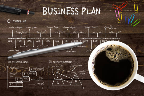 tasse kaffee auf businessplan - essgeschirr grafiken stock-fotos und bilder