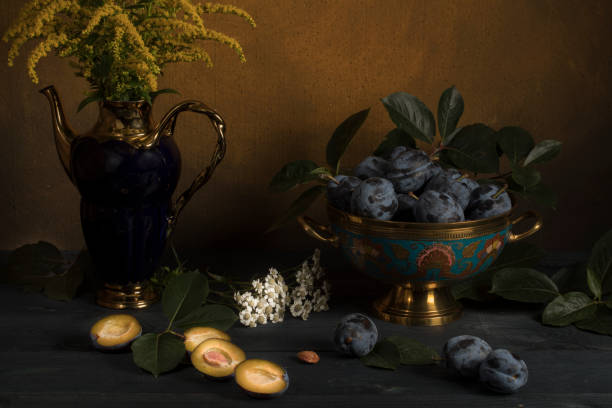 istock Plum in a vase on a table with flowers 1160000616