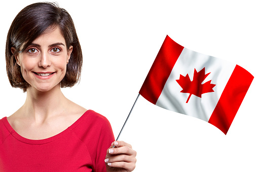 Young Woman Is Holding Canadian Flag On White Background
