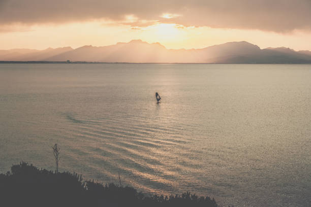 istock Sea sunset. Epic view from a cliff. Windsurfer silhouette 1160000857
