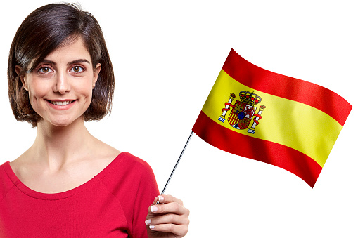 Young Woman Is Holding Spanish Flag On White Background