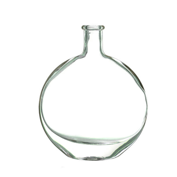 istock Old flat round glass bottle isolated on white. 1160001927