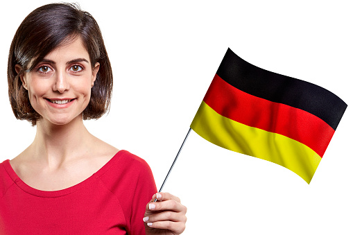 Young Woman Is Holding German Flag On White Background
