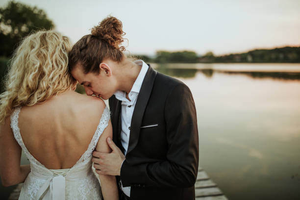 istock Bride and groom on lake pier 1160001964
