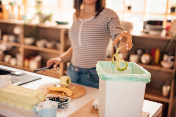 istock Millennial woman putting organic waste in compost bin 1160003523