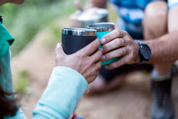 istock Couple having coffee in thermo cups at camp area 1160003644