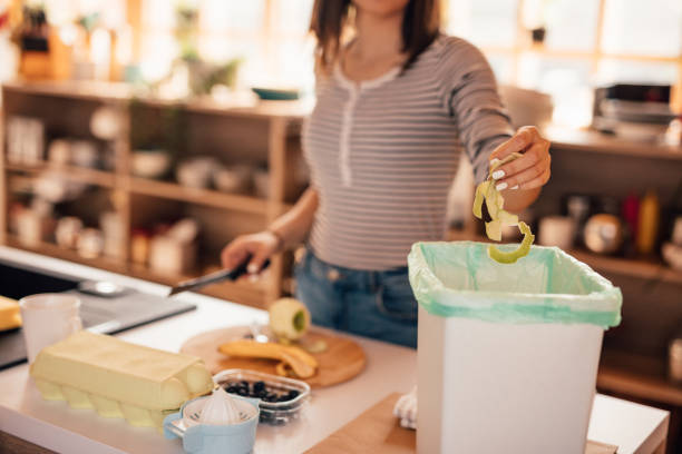 istock Millennial woman putting organic waste in compost bin 1160003650