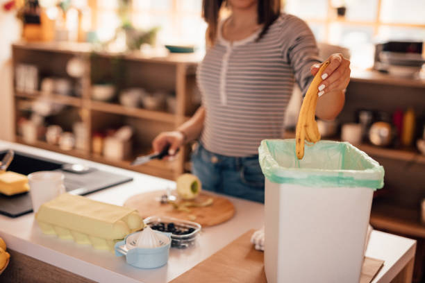 istock Millennial woman putting organic waste in compost bin 1160003706
