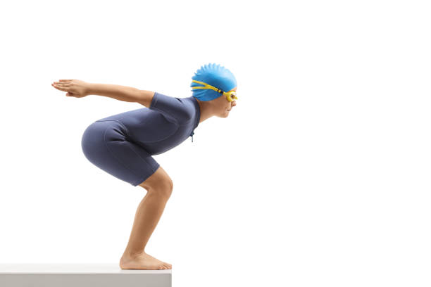 istock Boy in a wetsuit getting ready to jump for a swim 1160003723