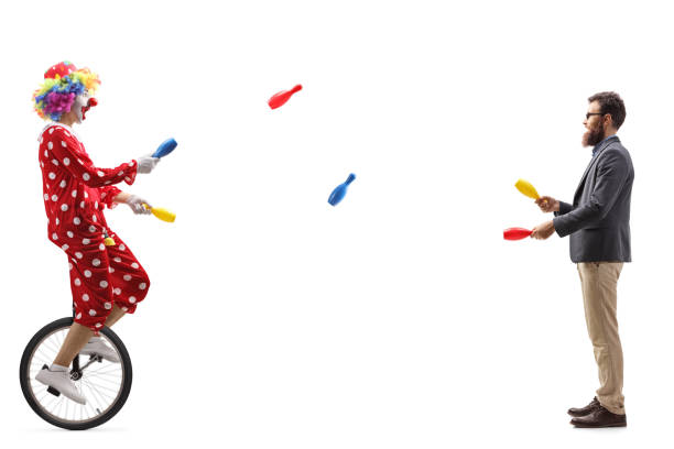 clown on a unicycle juggling with a bearded man - unicycle men young adult standing imagens e fotografias de stock