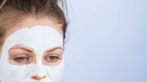 istock Girl with dry white mud mask on face 1160004539
