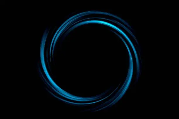 Photo of Abstract black hole with light blue circle on black background