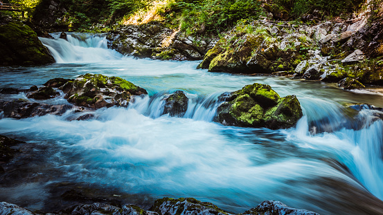 Long exposure of a waterfall on the East Lyn river flowing through the woods at Watersmeet in Exmoor National Park