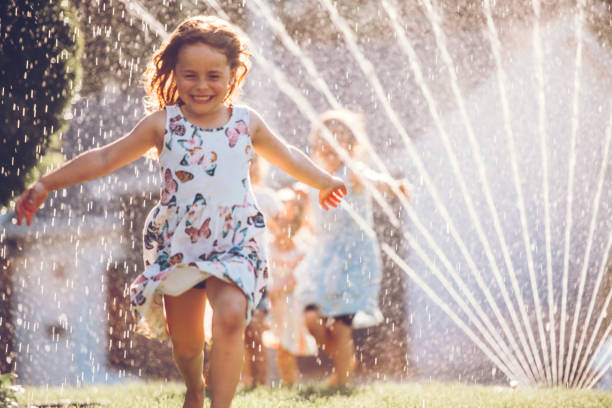 Kids playing with sprinkler