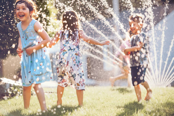 Kids playing with sprinkler