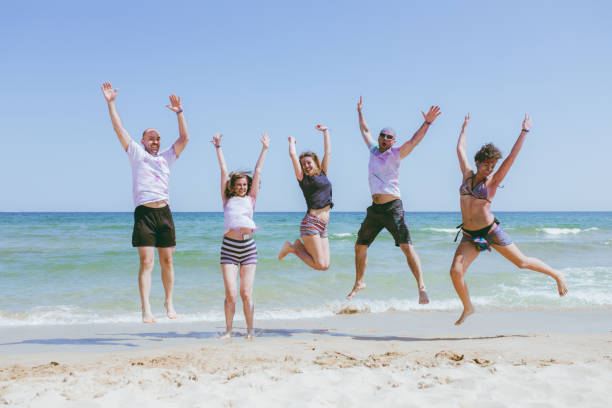 istock Jump of joy at the beach 1160005424