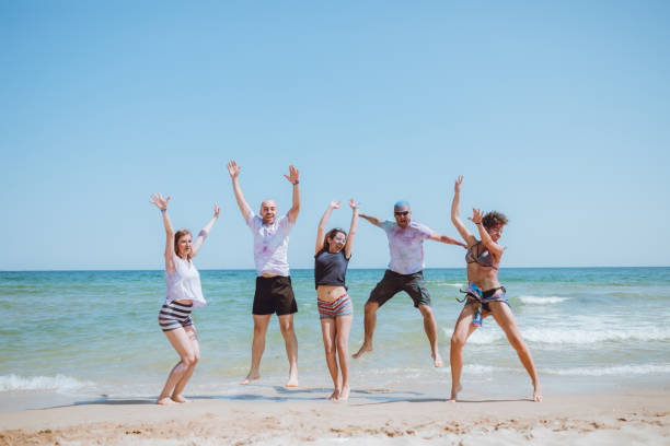 istock Jump of joy at the beach 1160005449