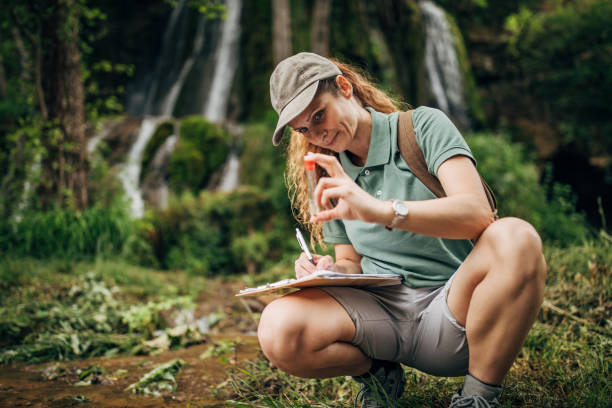 istock Biological researcher taking a water sample by the waterfall 1160006300