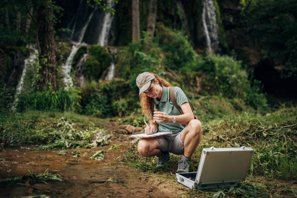 istock Lady biological researcher taking a water sample in nature 1160006384