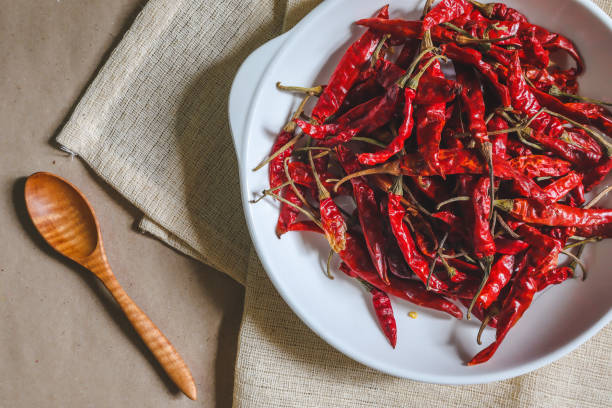 istock Dried chilli, red pepper in a white dish, ready to cook, food 1160007505