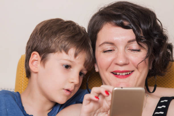 istock mother and her child watching something 1160008238