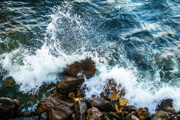 istock Waves hitting to the rock on a sea coast at evening 1160008947