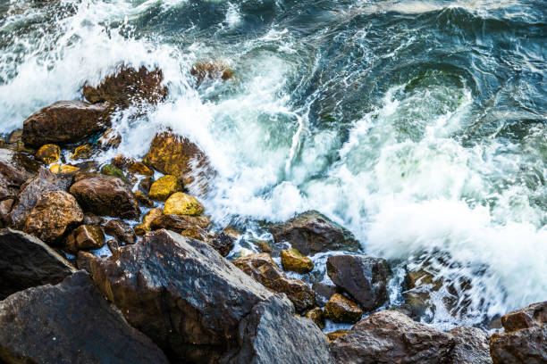istock Waves hitting to the rock on a sea coast at evening 1160008962