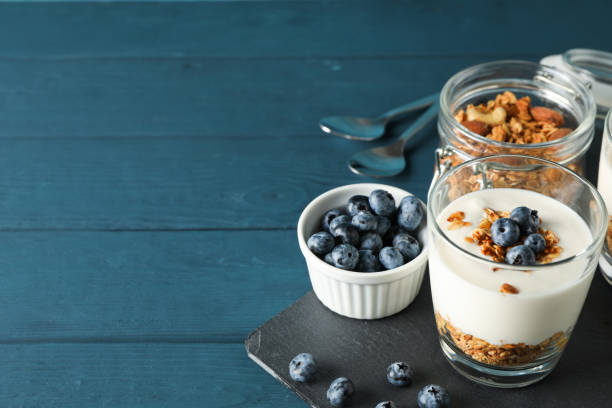 istock Composition with parfaits desserts on blue wooden background, space for text 1160010436