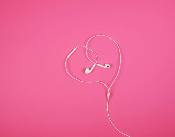 istock white headphones with a cable on a pink background 1160012356
