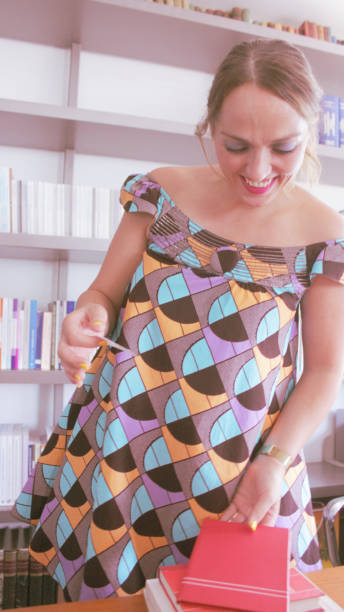istock Young woman Librarian cataloguing books 1160012740
