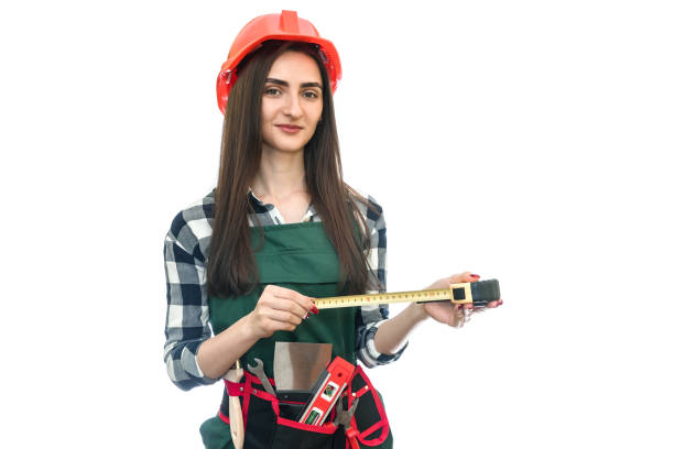 Woman in worker uniform with measuring tape isolated on white