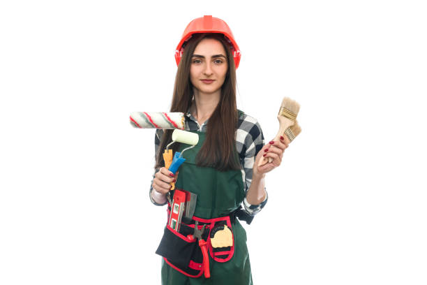 istock Young woman with painting tools isolated on white 1160013626