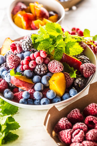 istock Frozen fruits blueberries blackberry raspberry red currant peach and herbs melissa 1160015646