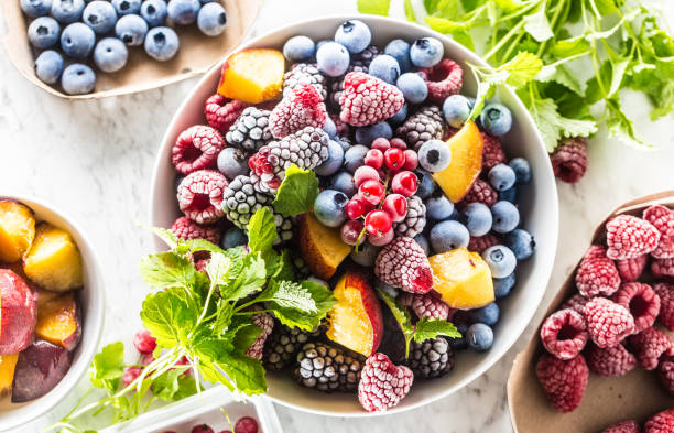 Frozen fruits blueberries blackberry raspberry red currant peach and herbs melissa