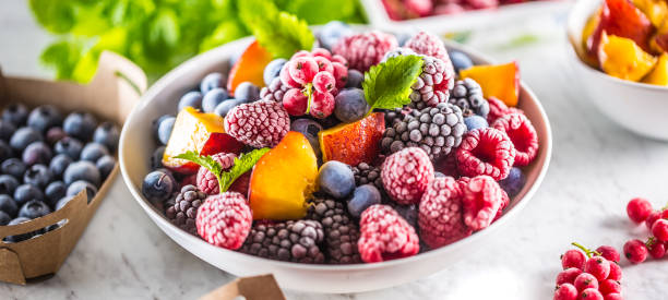 istock Frozen fruits blueberries blackberry raspberry red currant peach and herbs melissa 1160015685