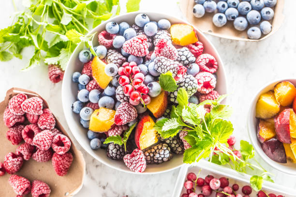 istock Frozen fruits blueberries blackberry raspberry red currant peach and herbs melissa 1160015699