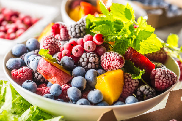 istock Frozen fruits blueberries blackberry raspberry red currant peach and herbs melissa 1160015702