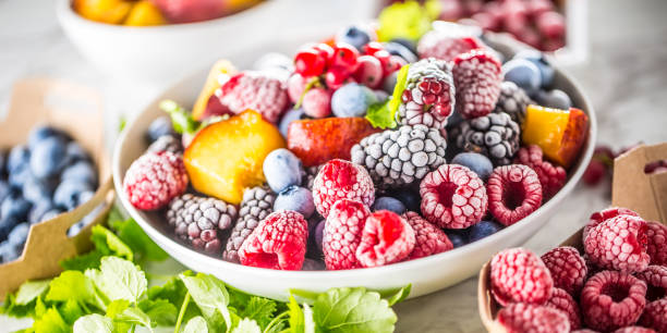 istock Frozen fruits blueberries blackberry raspberry red currant peach and herbs melissa 1160015715