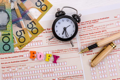 Clock with letters 'EOFY' on australian tax form