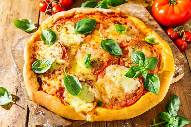 istock Homemade pizza with mozzarella on wooden background 1160017449