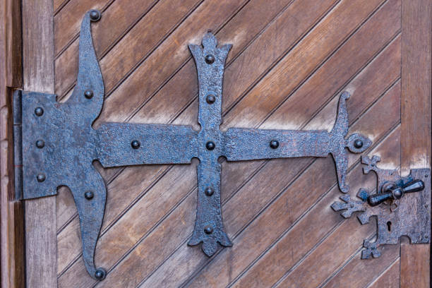 Close up of Cast iron decorated reinforcement on an ancient door.