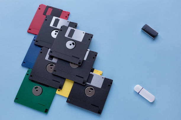 istock The evolution of digital data storage device. Floppy disks vs small flash drives. Isolated on a blue background. 1160019313
