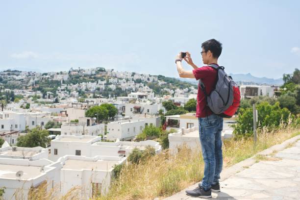 istock Traveler taking photos on his phone 1160020811
