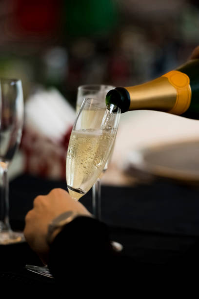 istock Man holding a glass with champagne 1160021131