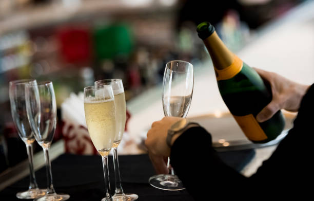 istock Man holding a glass with champagne 1160021182