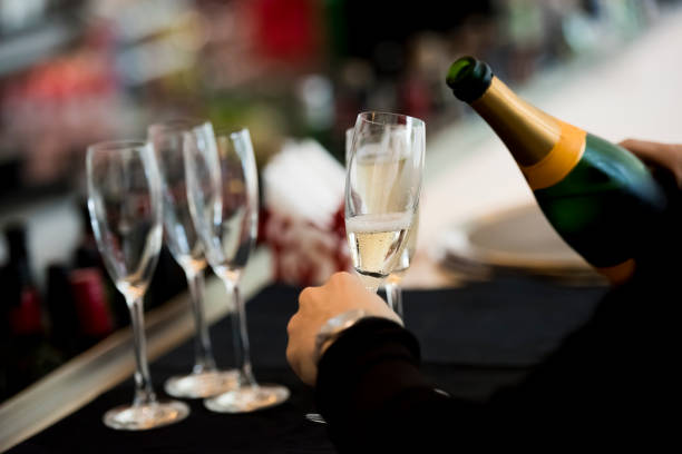 istock Waiter holding a glass with a champagne 1160021300