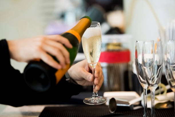 istock Human hand pouring champagne inside glass 1160021355
