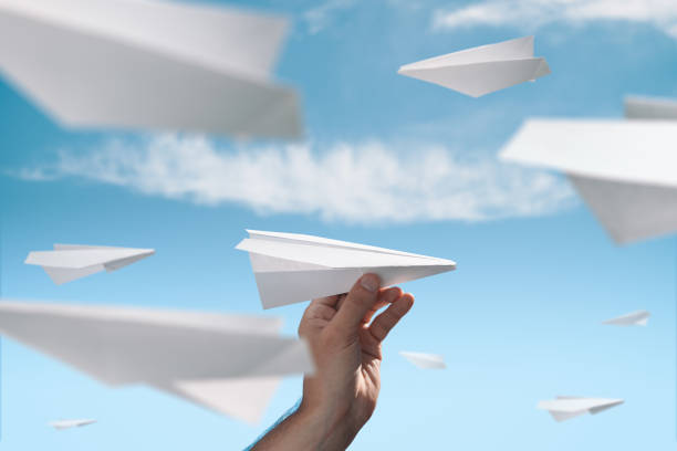 istock Male hand launches a paper plane 1160023664