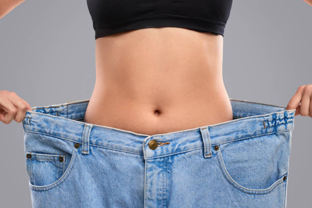 istock Dieting woman in oversized jeans 1160023863