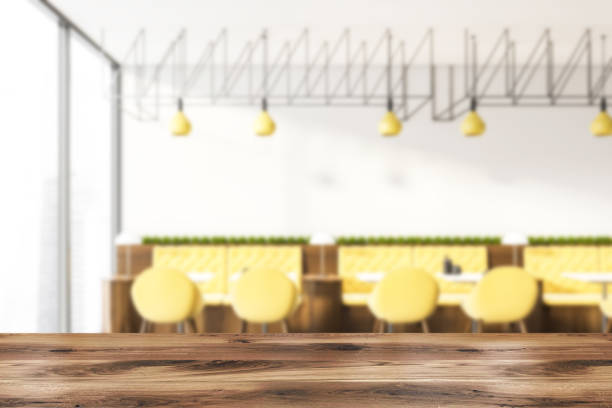 istock Interior of white cafe with yellow sofas blur 1160024041